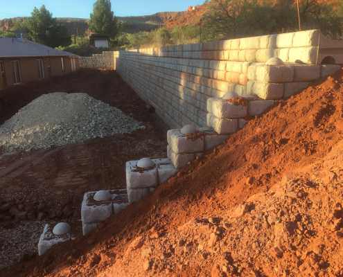Retaining rock wall construction